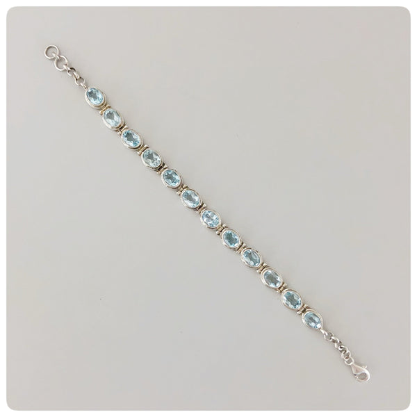 Sterling Silver and 12 Oval Faceted Blue Topaz Line Bracelet, Bali, New - The Silver Vault of Charleston